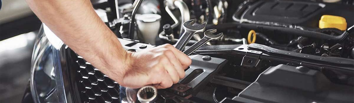 Auto mechanic working in garage. Repair service